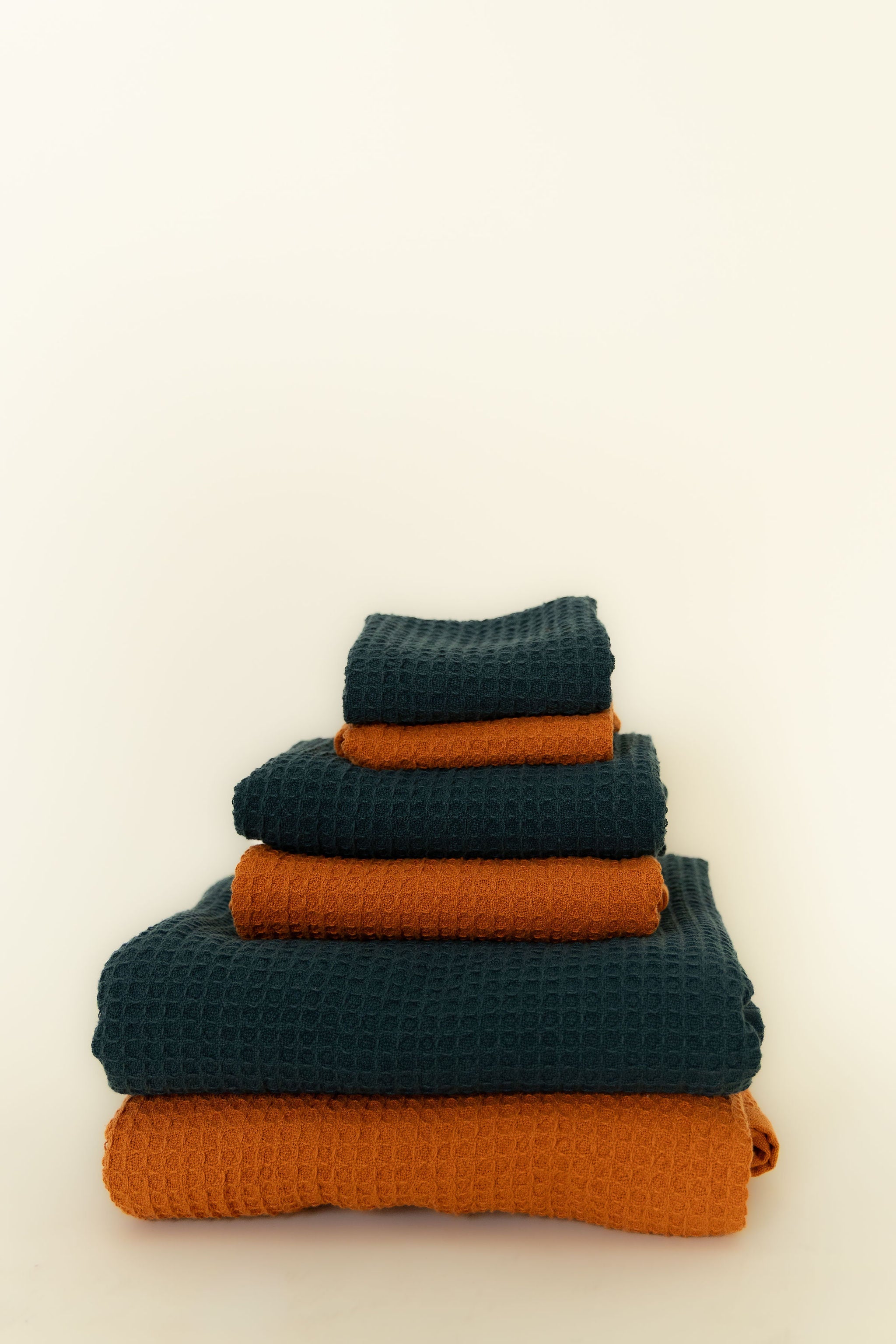 Stack of blue and orange towels on a white background